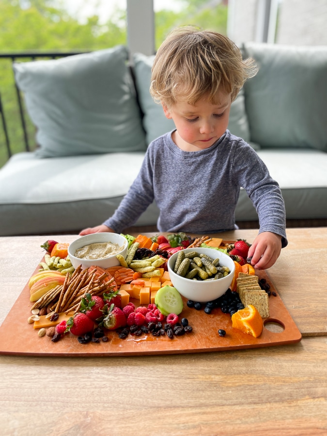 toddler reaching for Kids Charcuterie Board 