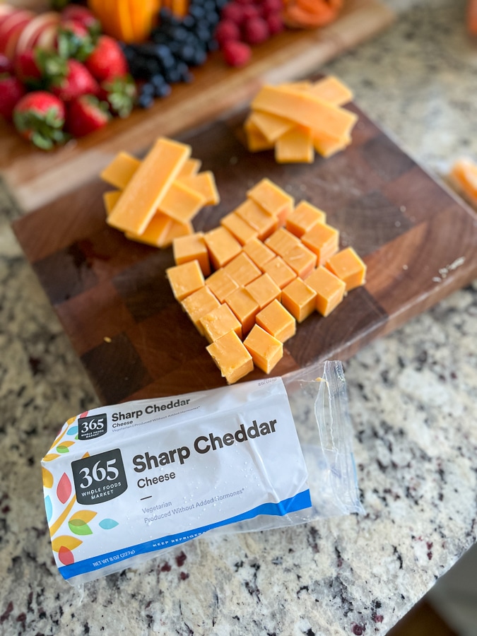 cheese cubes on a cutting board