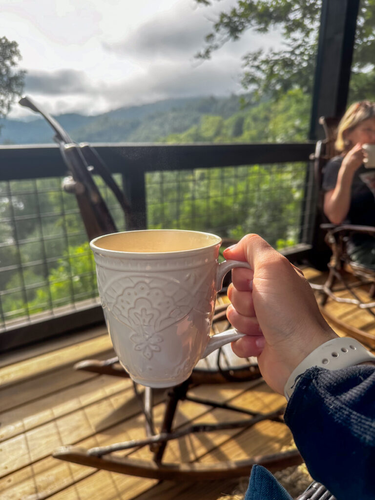 Kath Eats Blogger Kath Younger shares their Bear Lake Reserve vacation: in photo: person holding a mug